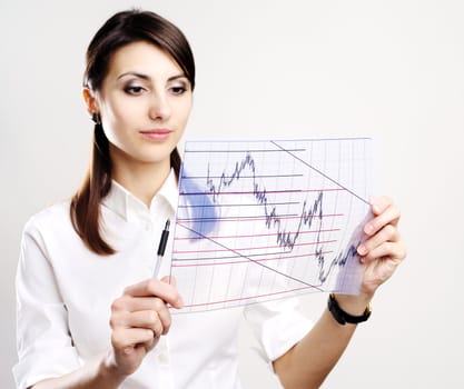 The businesswoman looks at the chart printed on a transparent material