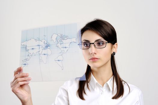 A girl with a map of the world printed on a transparent material