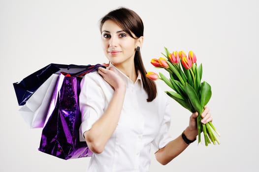 An image of nice woman with tulips and with bags