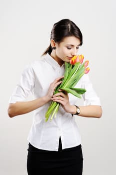 An image of young businesswoman with tulips