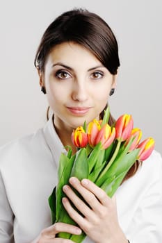 An image of young woman holding tulips