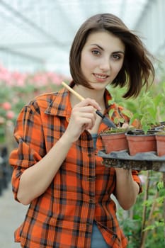 An image of a girl working in a greenhouse