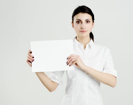 An image of young woman holding white paper