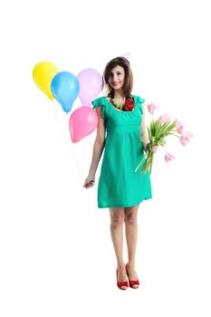 An image of happy young woman with birthday balloons and flowers