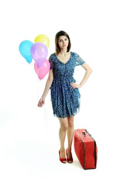 A young beautiful woman with balloons and a bag