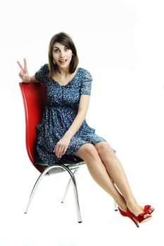 An image of a young girl sitting on a chair