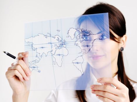 The girl with the map of the world printed on a transparent material