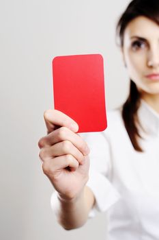 An image of beautiful woman showing red card