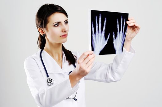 An image of female doctor examing x-ray