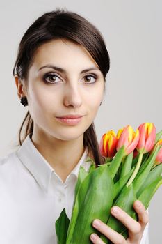 An image of young businesswoman with tulips