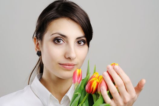 An image of woman with tulip flowers