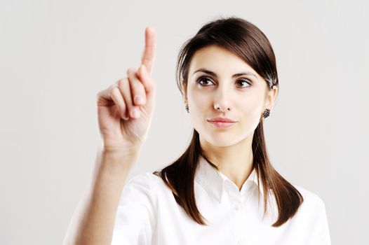 business woman pointing at something on screen