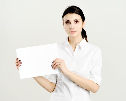 An image of young woman holding white paper