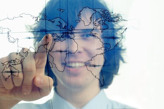 A young man with a map of the world printed on a transparent material