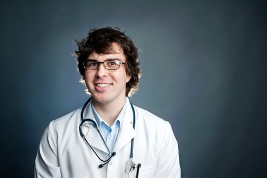 An image of a portrait of a young doctor in glasses