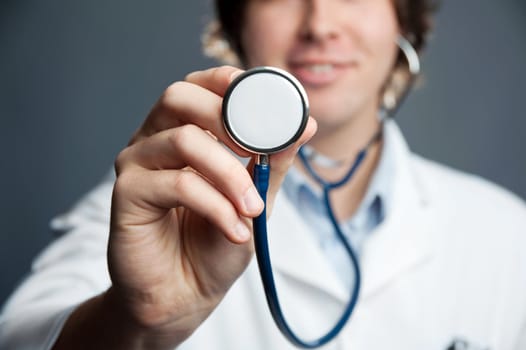 An image of a stethoscope in a doctor's hand