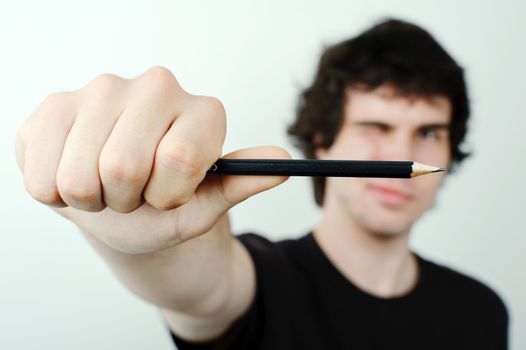 Man making eye-measure with pencil.