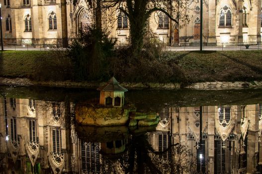 Johannes church in the middle of Feuersee in Stuttgart, Germany at night with great reflection - the church tower was destroyed during world war two. The lake was serving as water resort for the fire brigades many years ago...