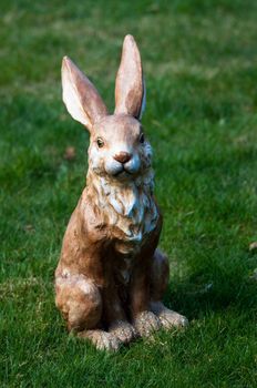 Easter decoration: Clay rabbit sitting in grass field