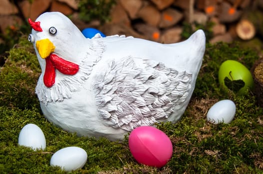 Easter decoration: Funny looking hen and eggs in a nest