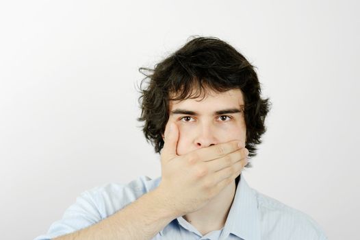 An image of a young man with his hand on his mouth