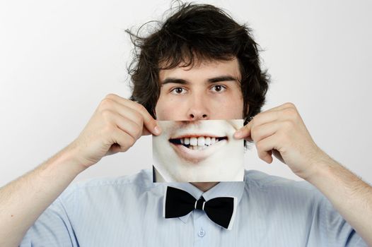 An image of a man with photo of a smile on his hands