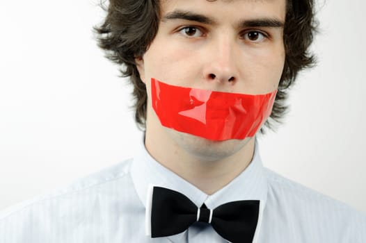 An image of a man with a tape on his mouth