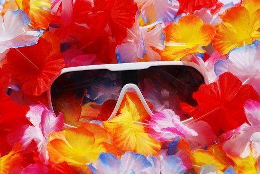 Sunglasses on flowerful lei. Celebrate your life and wear sunglasses at night