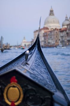 gondola trip during evening on canale grande, venice, italy, europe. In te earlier days those famous gondolas were colorful but Napoleon made them change to black