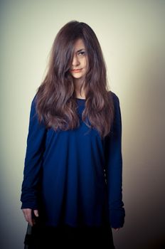 serious woman with long hair on vignetting background