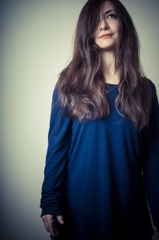 serious woman with long hair on vignetting background