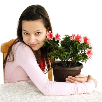 caucasian teenage girl hugging her potted plant, blooming pink azalea