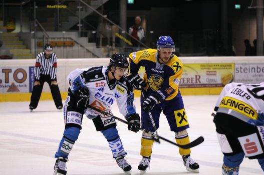 ZELL AM SEE; AUSTRIA - OCT 01: Austrian National League. Face off on the blue line of EKZ. Game EK Zell am See vs Linz II (Result 5-2) on October 01, 2011 in Zell am See.