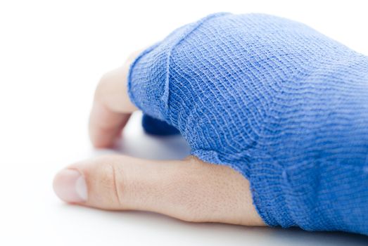 bandaged broken male hand on white background and shallow depth of field and copy space