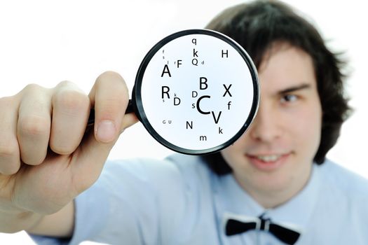 A young man with a magnifier with letters in it