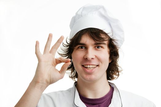 An image of a cheerful young chef in white hat