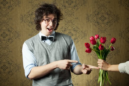 An image of a young man in big glasses and flowers