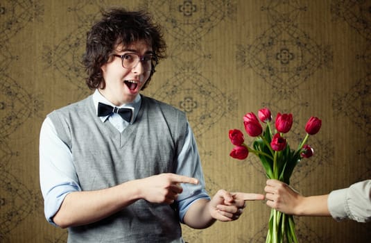 An image of a young man in big glasses and flowers