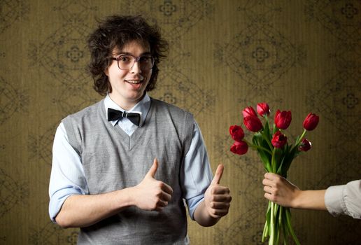 An image of a man in big glasses and red flowers