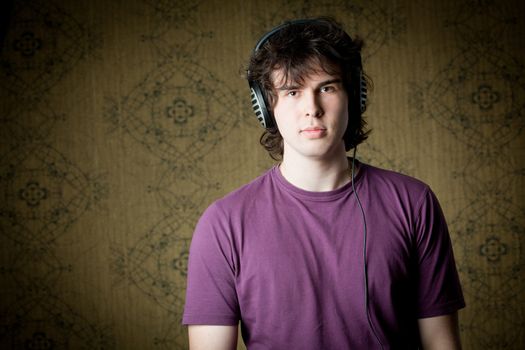 A handsome young man listening to music in headphones