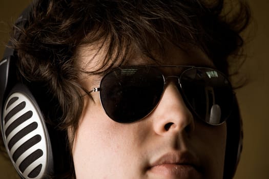 A portrait of a man listening to music in headphones