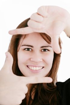 Beautiful young woman creating a frame with her fingers