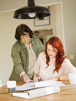 Grandmother helping her grandaughter with paperwork