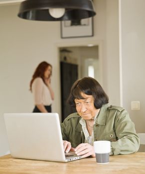 Senior woman by the computer