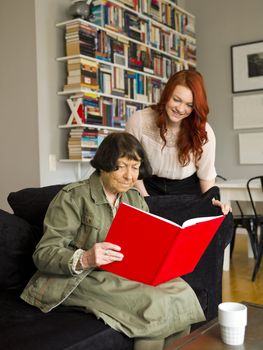 Young woman and her Grandmother looking in the Photo Album