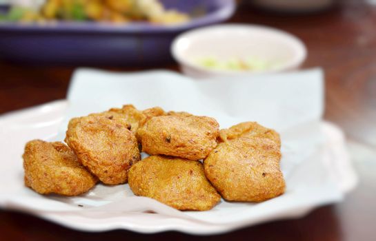 Spicy fried fish cake (Tod Mun Pla) served with cucumber in sweet sauce