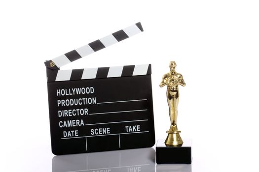 Movie clapper board and fake Oscar over white 