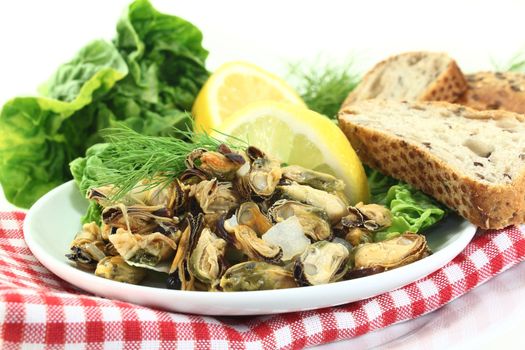 a plate of marinated mussels and dill