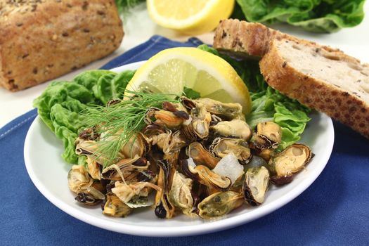 a plate of marinated mussels and dill