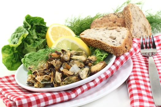 a plate of marinated mussels and dill